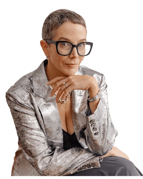 Seated woman with glasses and silver blazer